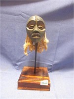 carved mask decor on stand
