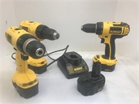 Three cordless DeWalt drills with battery charger