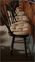 Three wooden bar stools with covers