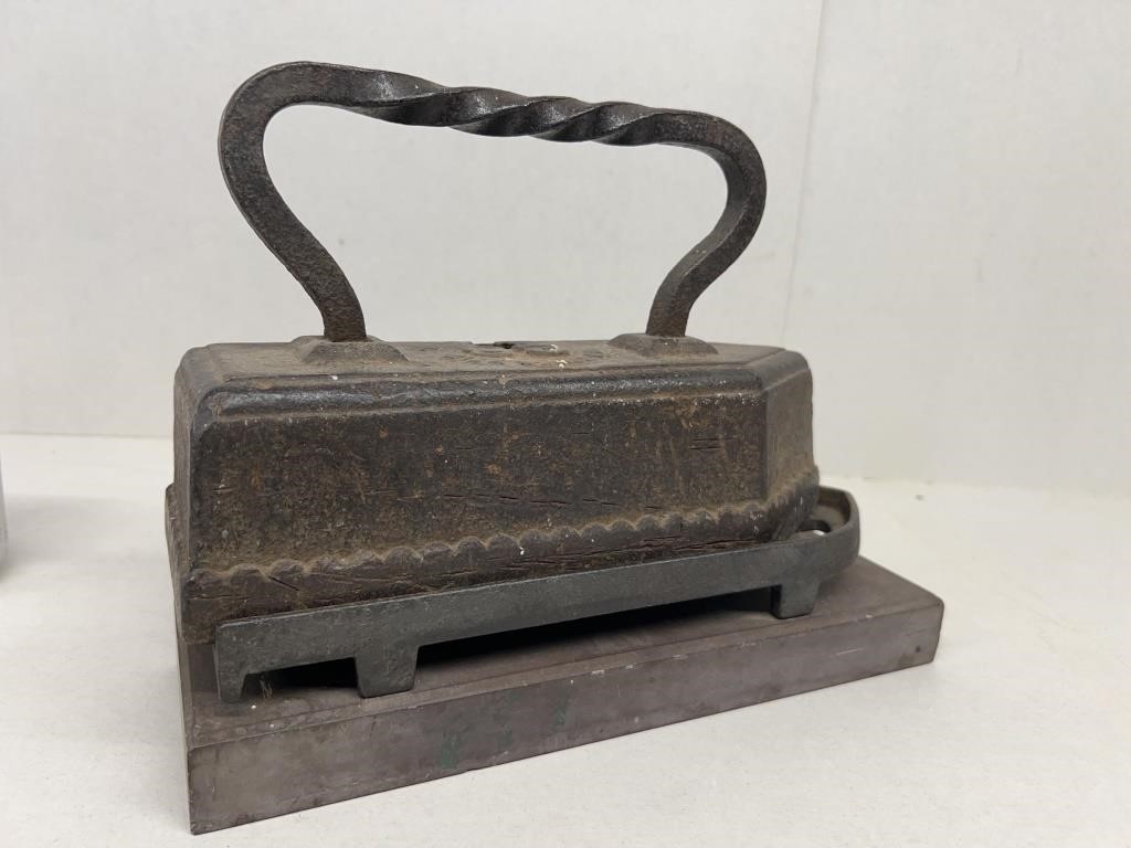 Cast-iron antique tailors iron with resting p