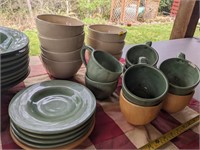 Large set of ceramic plates, bowls, and mugs