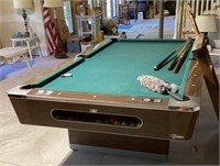 Wood pool table with balls and cues