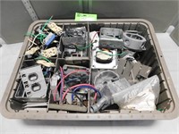 Plastic bin with assorted electrical boxes, plugs,