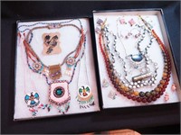 Two containers of beaded jewelry including