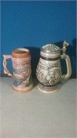 Group of two Steins one lidded featuring cars