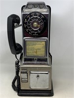 Vintage automatic electric company pay phone has