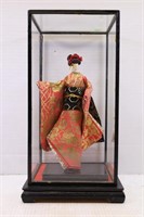 ORIENTAL DOLL WITH SILK DRESS IN DISPLAY CASE