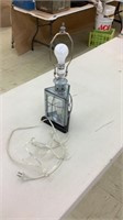 Decorative metal lamp with glass bottom