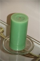 Green candle on glass base