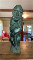 Large carved stone human figure, signed on the