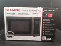 New Sharp Carousel 1.4 cu ft Microwave Oven.