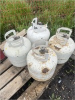 four of 20 pound propane bottles empty