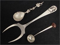 Two silver spoons and a silver serving fork