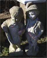 Concrete girl and boy statues, weathered