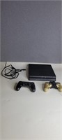 PLAYSTATION 4 CONSOLE AND TWO CONTROLLERS