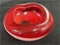 Vintage glass ashtray with red white swirl.