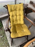 Vintage carved wooden rocking chair with tufted ve