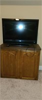 Vizio tv with a wood tv stand