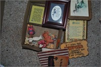 small box of pictures and teddy bear figurines