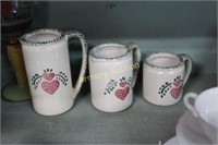 HEART DECORATED POTTERY MEASURING PITCHERS