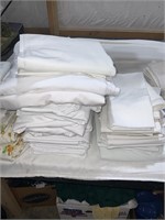 large stack of white sheets and pillow cases