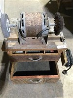 Bench grinder on 2-drawer wood cabinet