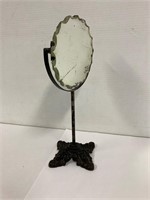 Cast iron base dresser mirror. 13” tall.