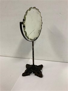 Cast iron base dresser mirror. 13” tall.