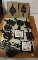 Cast iron trivets, most of them marked Wilton