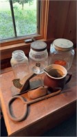 Three antique glass storage jars, one monarch