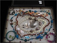 Container of jewelry including abalone,