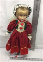 D2) COLLECTOR PORCELAIN DOLL DRESSED IN RED WITH