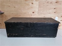 large black trunk, inside lined w/ newspapers