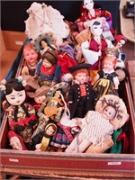 Box of small international dolls including