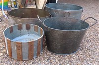 four larger galvanized metal tubs