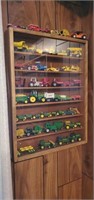 Shadow box of miniature farm toys, John Deere