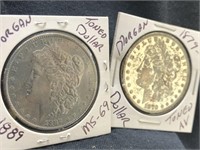 Lot of 2 Morgan silver dollars with protectors