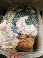 tub of linens, baskets and decor