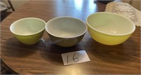 Three Pyrex green and yellow nesting bowls