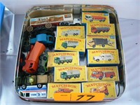TIN WITH MATCHBOX CARS AND TRUCKS IN ORIGINAL