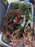 A tote of Christmas greenery and 2 totes of