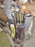 3 golf bags with clubs