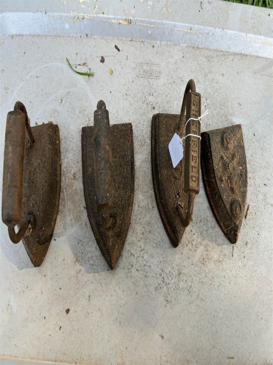 4 antique irons, one missing handle