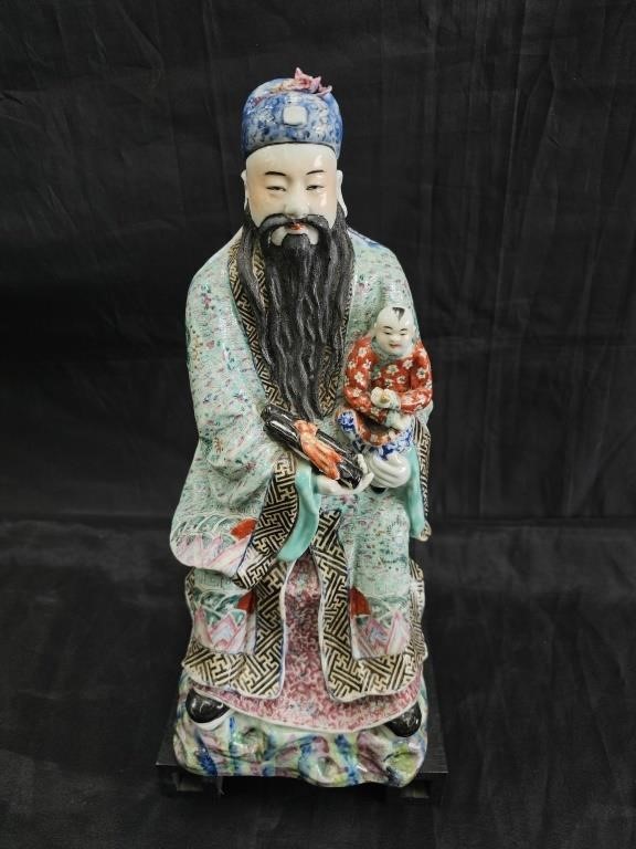 Vintage Chinese porcelain emperor on a wooden