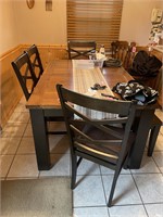 dining table 4 chairs & bench has leaf under table