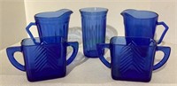 Vintage blue glassware includes two creamers,