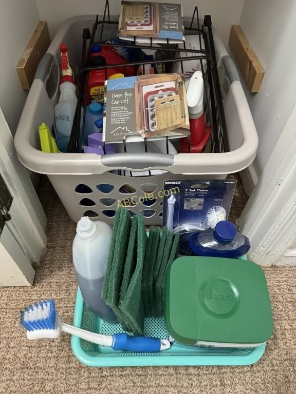 Grey laundry basket full of household cleaning