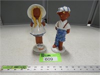 Red Wing boy and girl figurines; girl has been rep