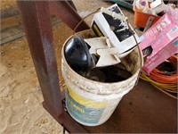D- BUCKET OF LUBRICANTS AND TRACTOR PARTS