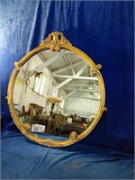 A beautiful golden coloured circle mirror no
